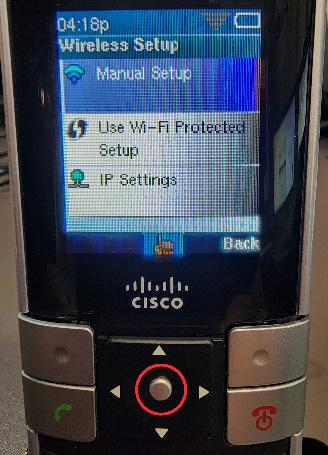 Picture of the Cisco WIP310 cordless phone with a circle highlighting the Select button, but also showing the Manual Setup menu option being highlighted