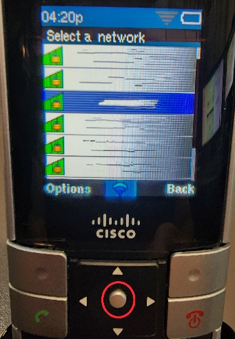 Picture of the Cisco WIP310 cordless phone with a circle highlighting the Select button, but also showing the Select a network screen with a blurred-out list of wireless networks